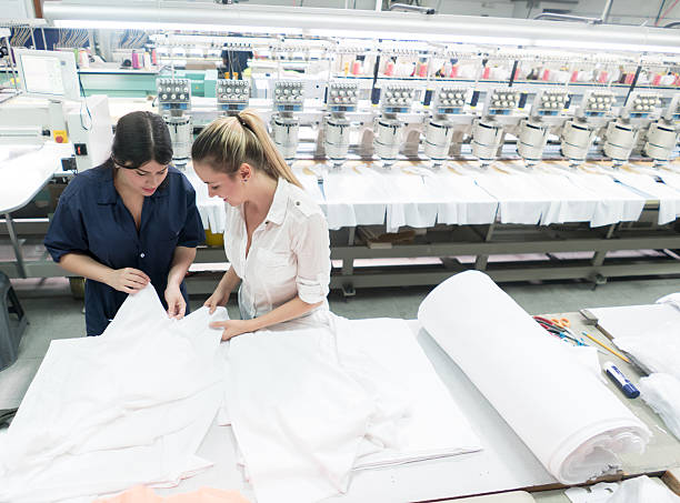Women working at an embroidery factory and supervising the machines as they work
