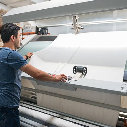 Textile quality controller checking fabrics  in the textile mill